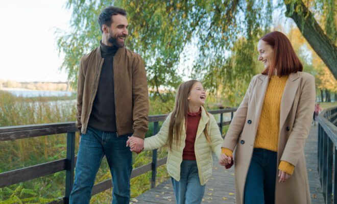 Caucasian happy family weekend holiday at nature outdoors laughing smiling in city autumn park