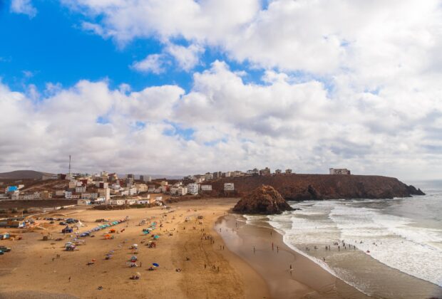 Panoramic view on Atlantic ocean beach in small Morrocan town Iguer Ouzrou