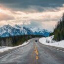 Road trip with rocky mountains on highway road in national park at Canada