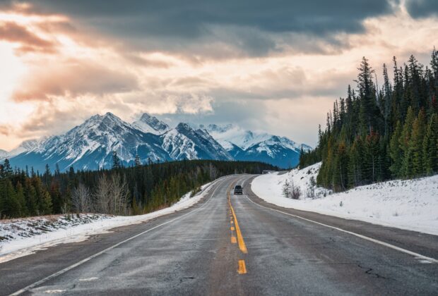 Road trip with rocky mountains on highway road in national park at Canada