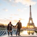 Shot of the happy couple taking pictures with Eiffel Tower on the background, Paris, France
