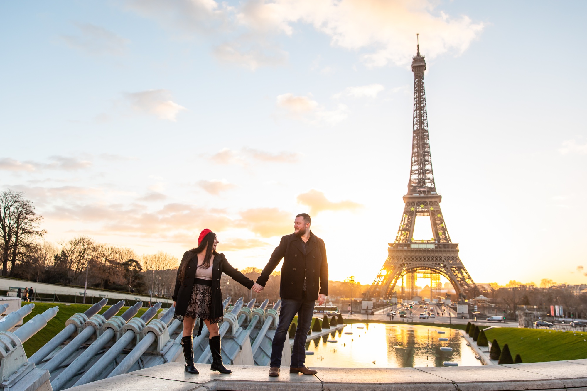 Shot of the happy couple taking pictures with Eiffel Tower on the background, Paris, France