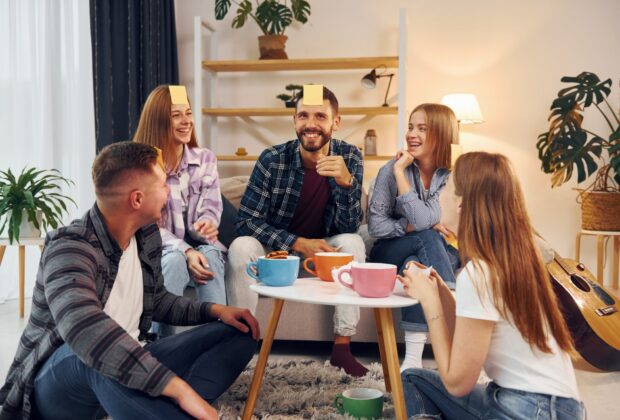 Trying to guess who I am. Group of friends have party indoors together